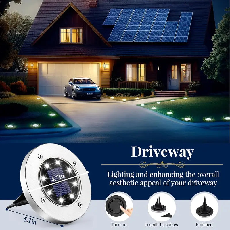 Solar ground lights illuminating driveway at night