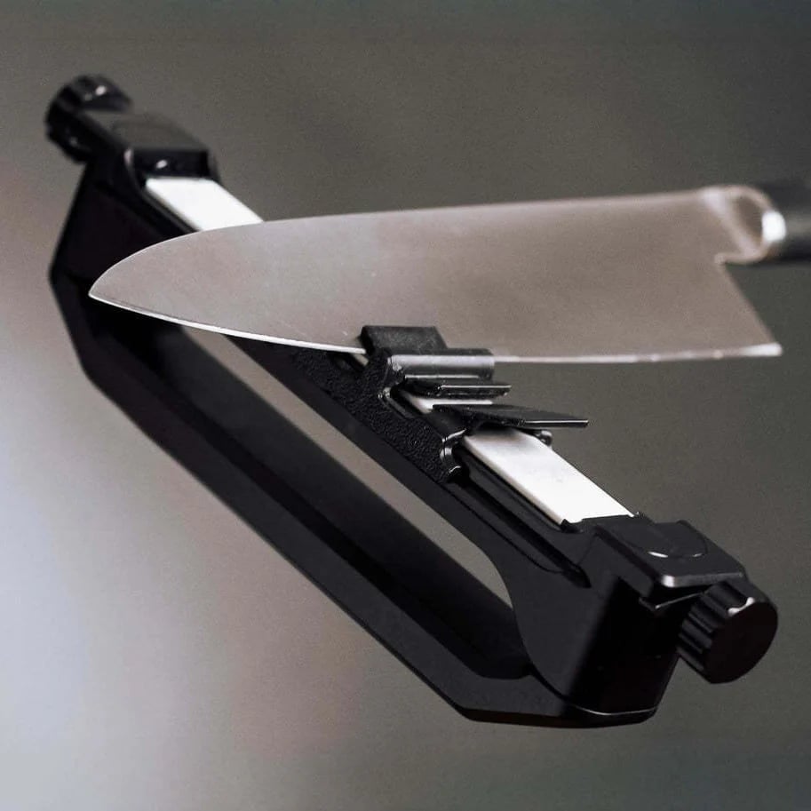 Kitchen knife positioned in guided sharpener
