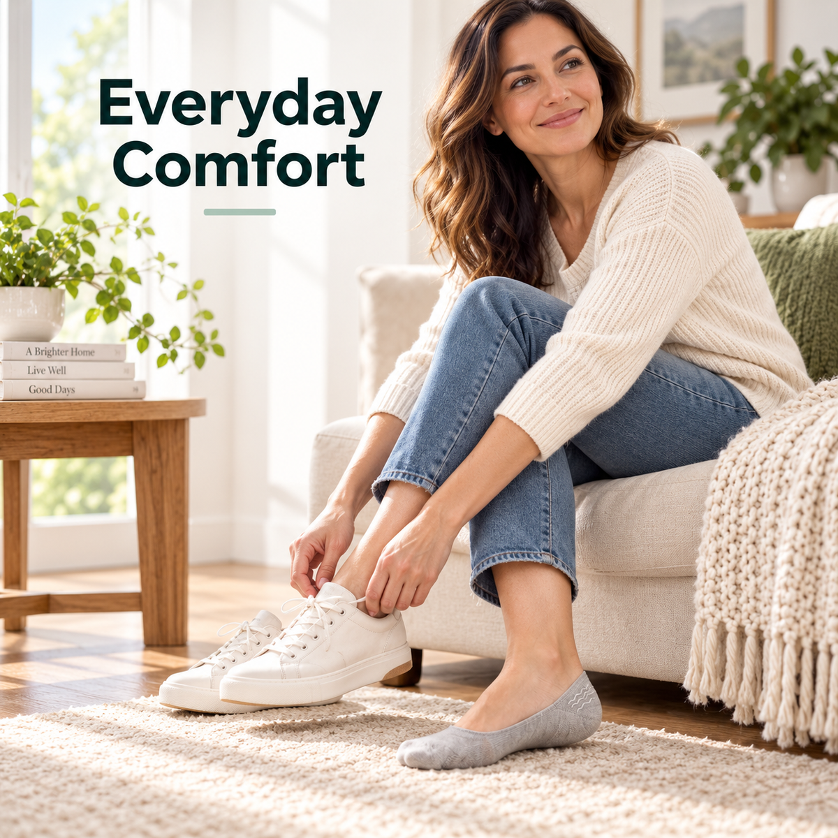 Woman wearing gray cushioned no-show socks at home while slipping on white casual sneakers