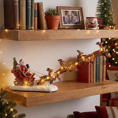 🎅 Lighted Santa Sleigh & Flying Reindeer Figurine – Warm LED Christmas Decor